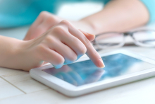 Patient using digital device to enter information.