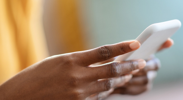 woman's hands holding a cell phone